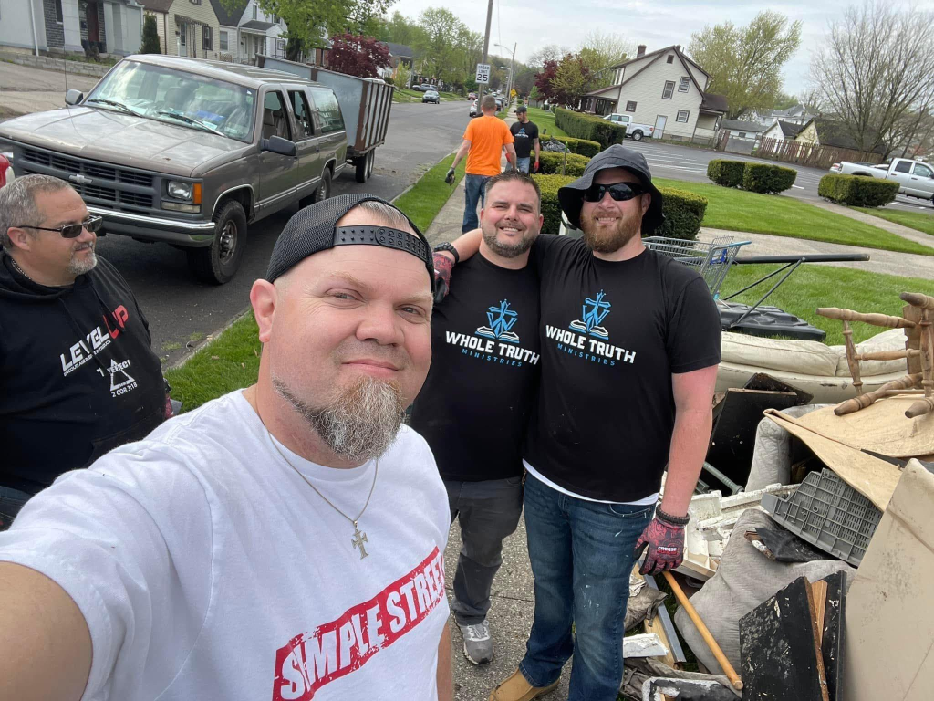 Men from Whole Truth Ministries participating in an outdoor community service and recovery outreach event.