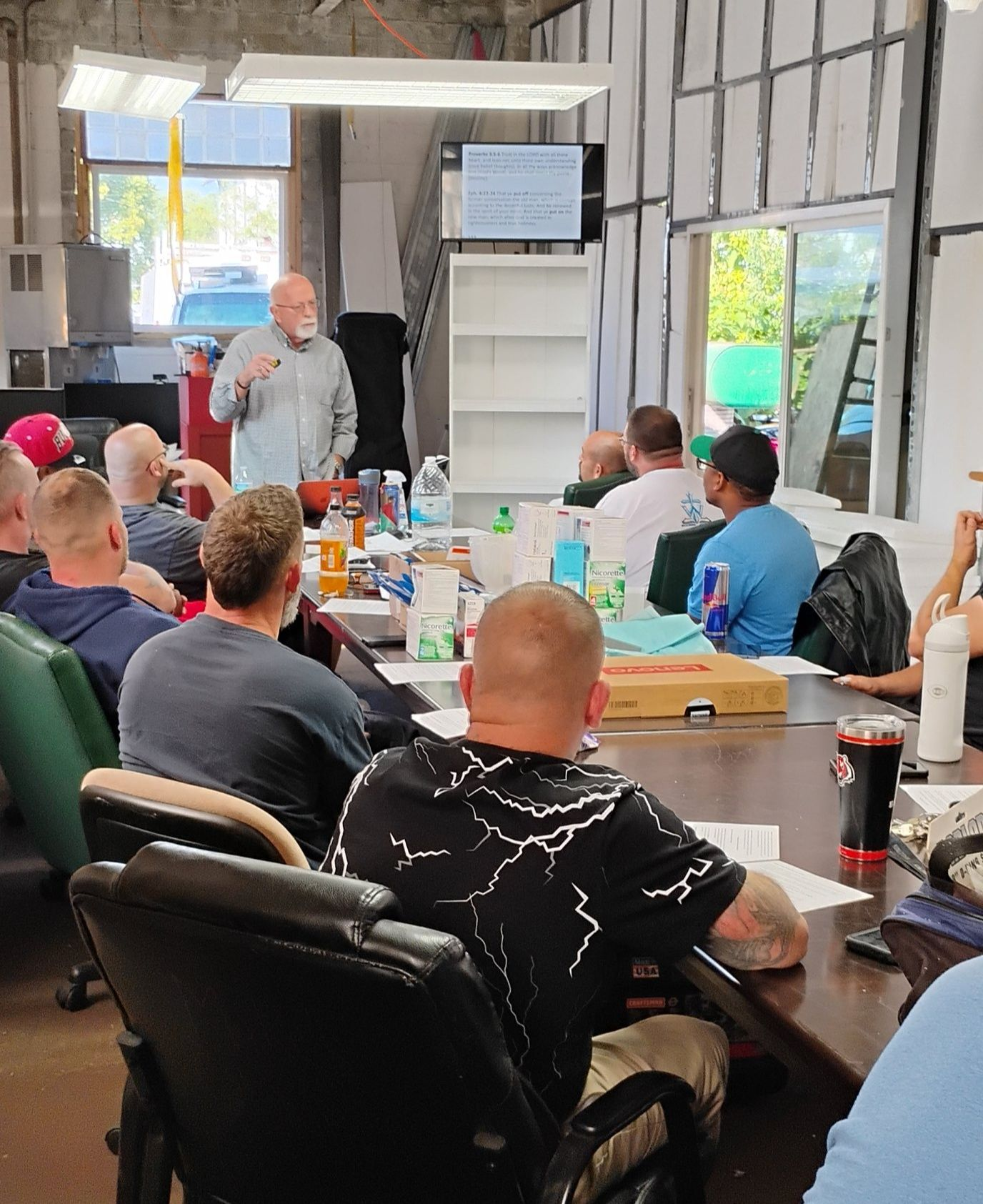 Man and a staff meeting up lecturing on a topic